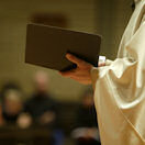 Priest holding bible