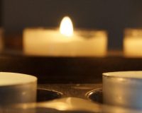 Picture of tea light candles in holders suggesting prayer candles.