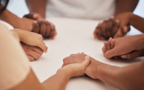 People holding hands, praying